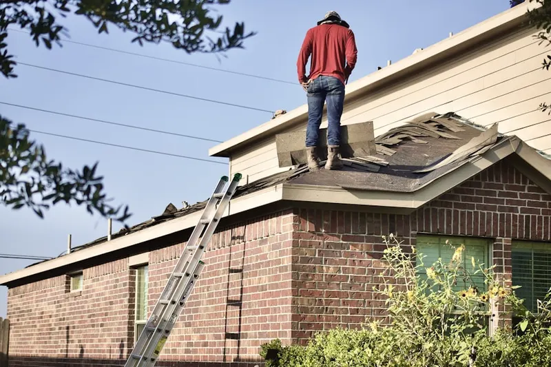 Professional roofer working on a residential roof in Mansfield